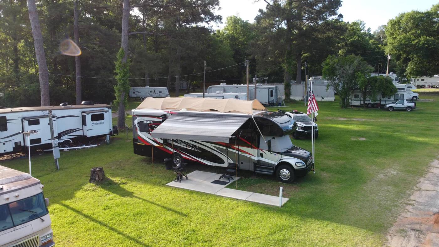 Motorhome and travel trailers on grassy RV sites